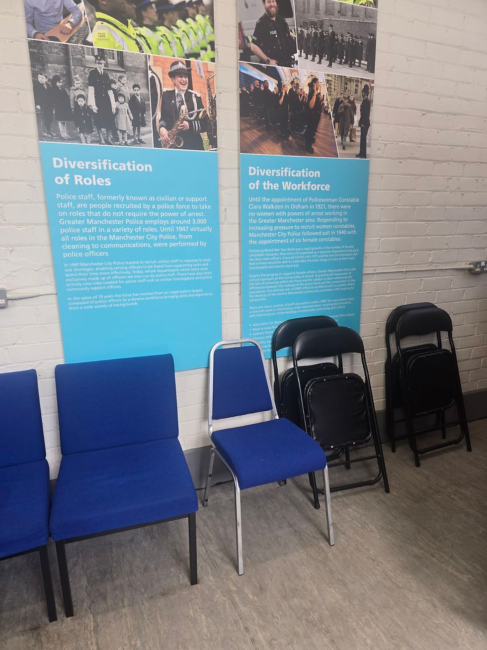 Museum display panels and chairs in a visitor area.