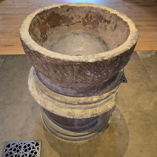 Ancient stone baptismal font inside the Church.