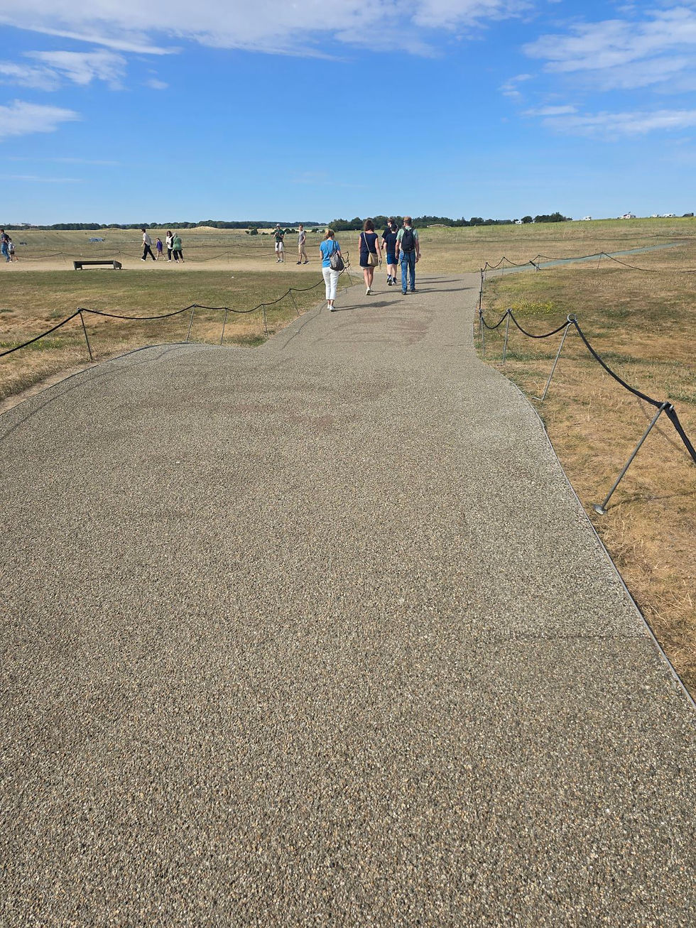 The path around the monument highlighting one of the larger bumps that makes navigating it difficult for those with mobility aids or disabilities.
