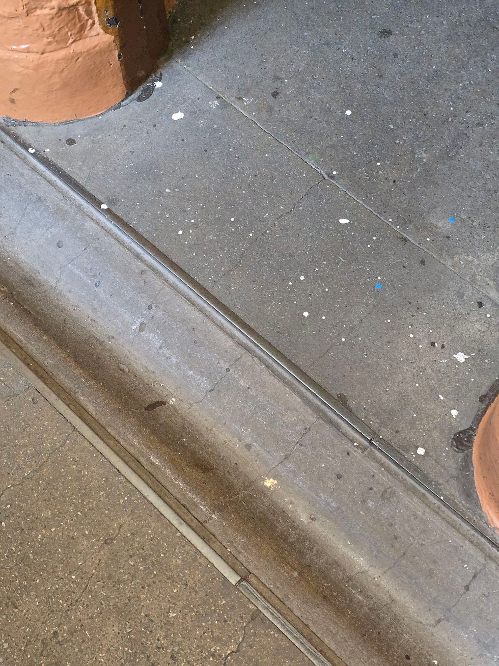 A small metal door threshold at the Police Museum entry.