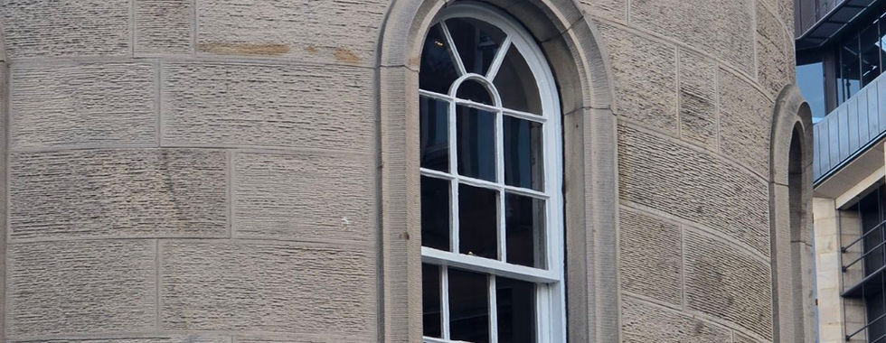Arched window in a stone tower on an Edinburgh Ghost Bus Tour.