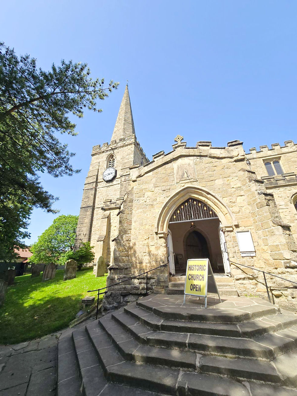 Stone entrance and spire of St Peter and St Paul's Church.