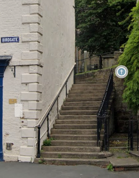 Stone stairs with handrails outside the Church.