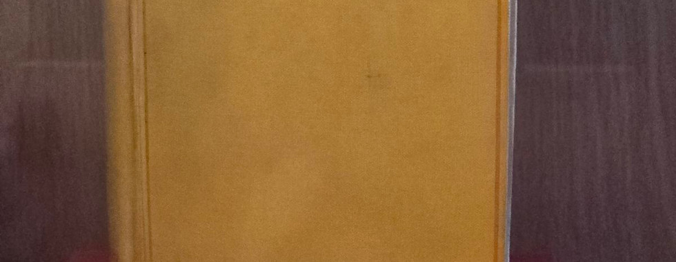 Yellow book cover of a signed first edition of Dracula by Bram Stoker at Whitby Abbey
