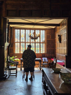 Bob exploring the great hall in Speke hall with his rollator.
