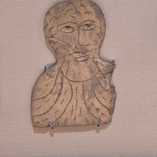 A stone artifact from the museum showing a carving of a man.