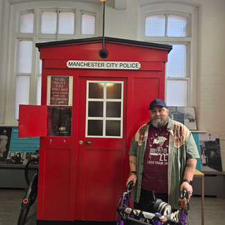 Bob and his rollator by a Manchester City Police box.
