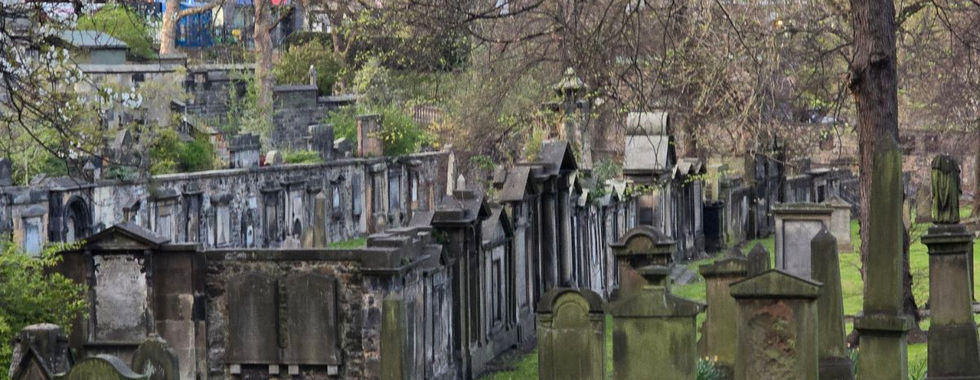 Greyfriars Kirkyard cemetery with old tombstones and trees.