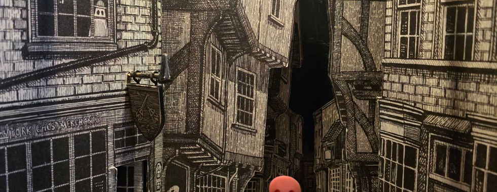 Small ghost figurines in a model street of York.