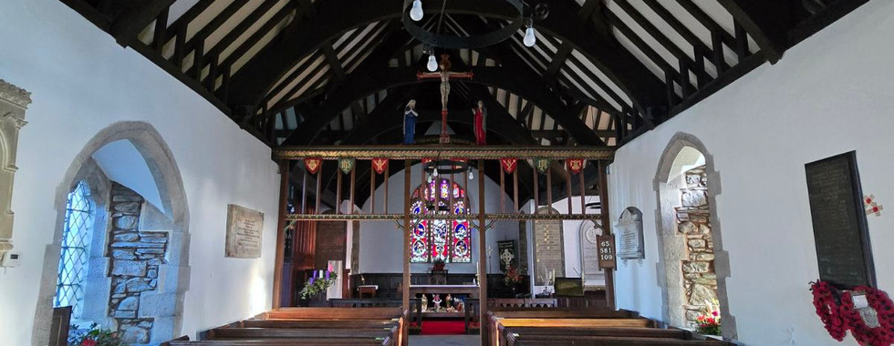 Interior of St. Digain's Church with wooden pews and roof beams.