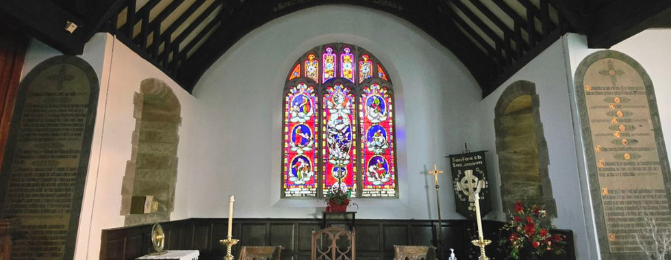 Interior of St. Digain's Church with altar and stained glass.
