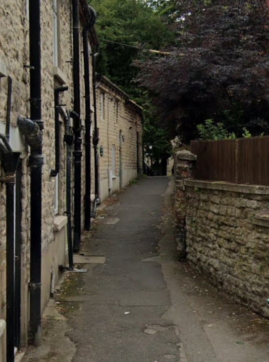A narrow stone alleyway, the step free route to the church.