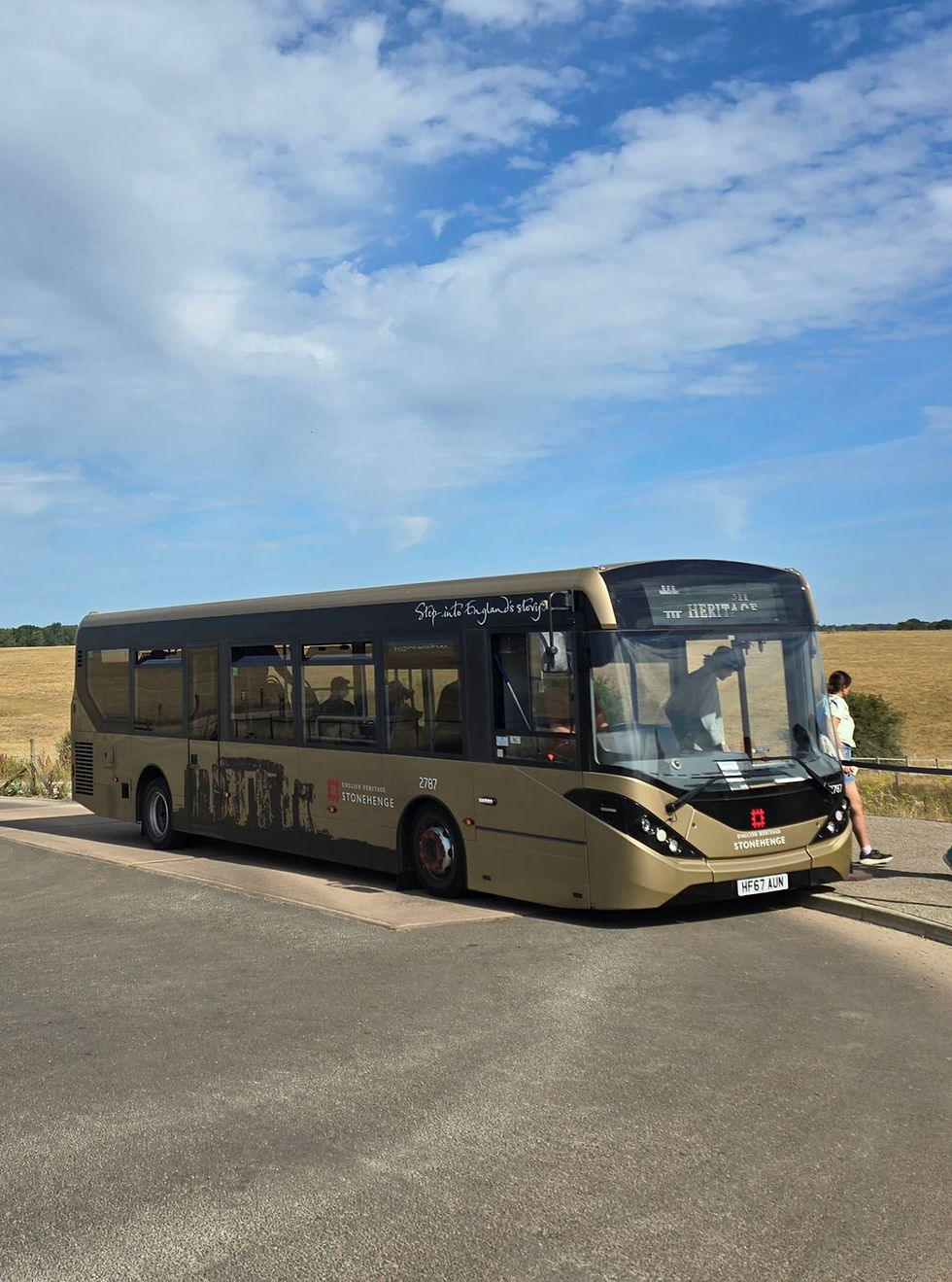 One of the shuttle buses that takes visitors from the visisotr centre to the monument and back again. It is gold in colour and looks just like a single decker bus.