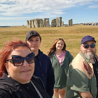 A selfie of Lise, Bob and their children in front of Stonehenge.