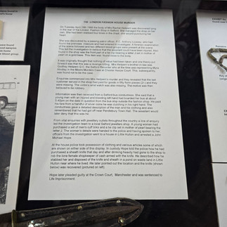 Museum display of police history documents and a sheath.