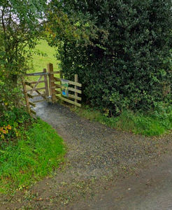 Accessible gravel path leading to a timber kissing gate.