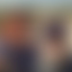 A picture of Lise and Bob. It is a selfie and they are both wearing sunglasses. The ruins can be seen behind them.