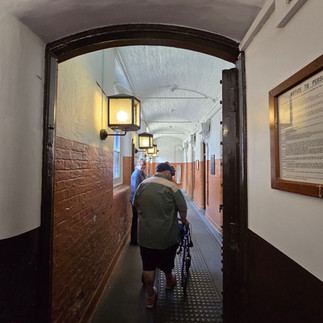 Bob using his rollator in the prison corridor.