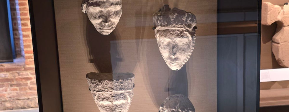 Ancient stone carved faces on display at Whitby Abbey museum.