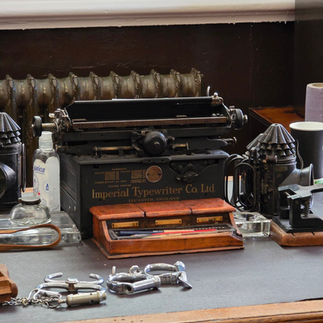 Vintage typewriter and handcuffs on a police desk.