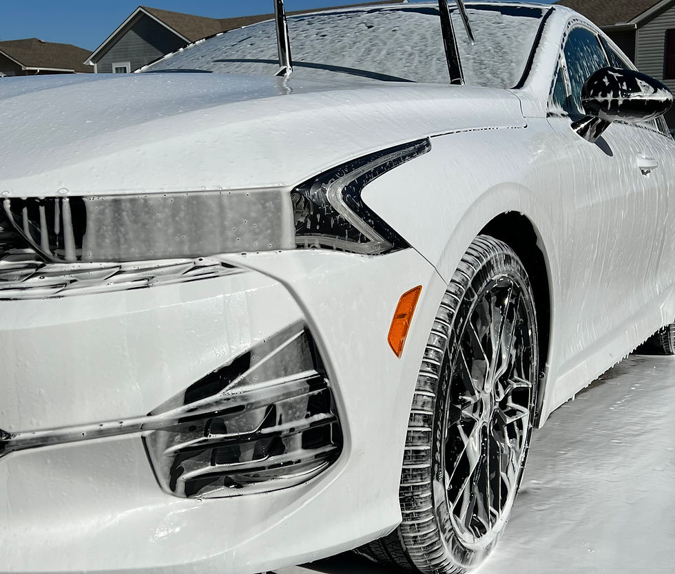 2023 Kia K5 sedan covered in thick foam during exterior auto detailing wash at Devil Dog Detailing in Kansas City.