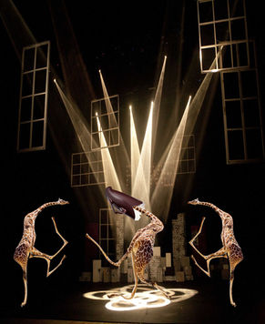 Student-created digital artwork featuring three dancing giraffes creatively posed in a black and gold imaginative environment using Photoshop Puppet Warp, compositing, and visual storytelling techniques.