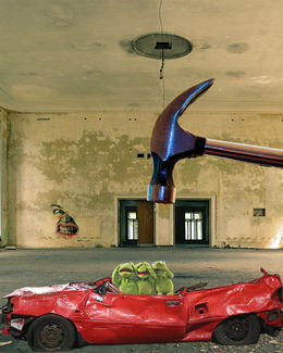 Student-created surreal digital composition inspired by Salvador Dalí and using Photoshop compositing techniques featuring Kermit the Frogs in a red car with a dropping hammer.