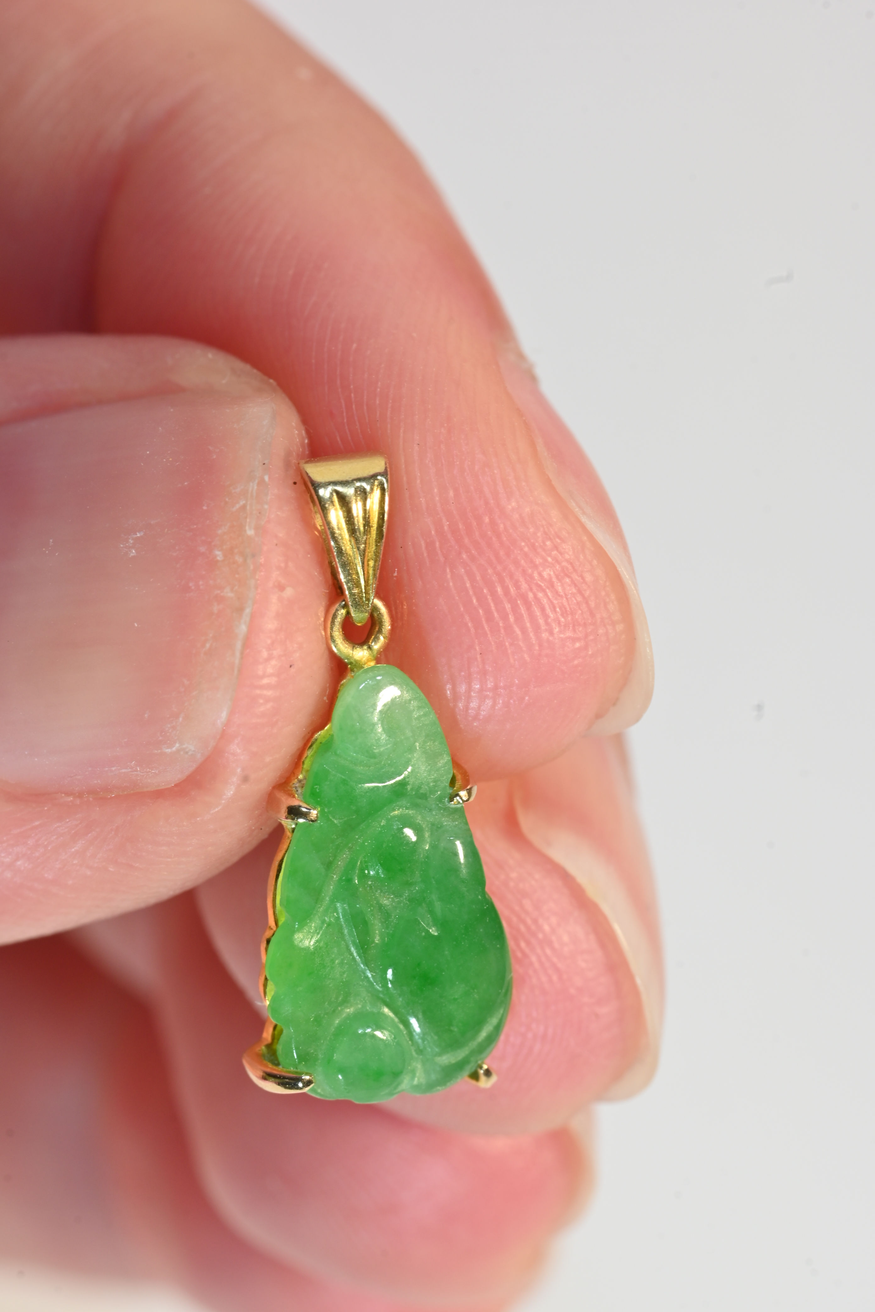 14 carat gold and jade carved pendant