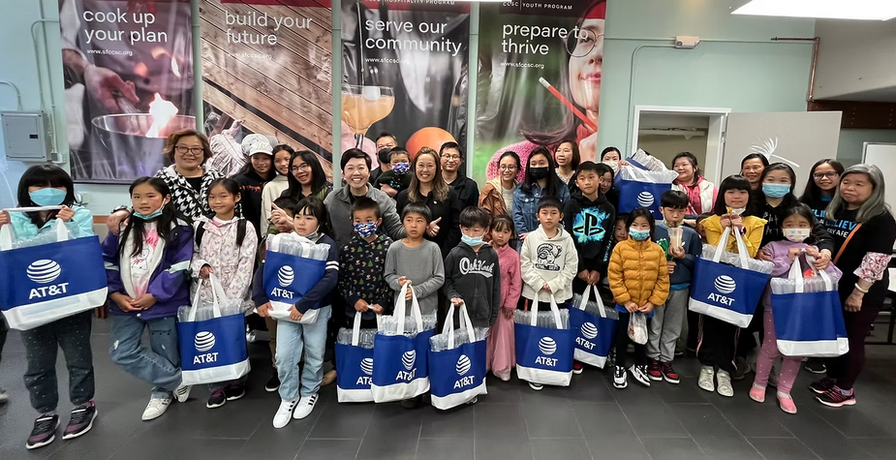 Community members at laptop giveaway with AT&T group photo