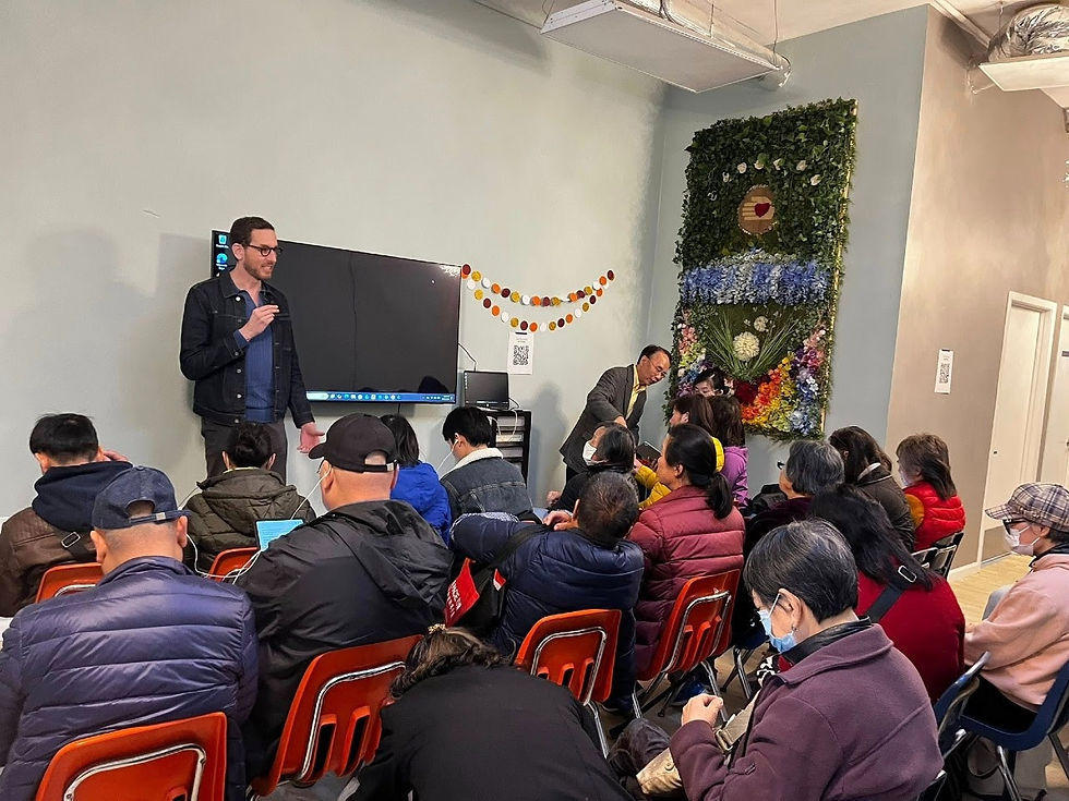 Man speaks to a seated audience at a community event