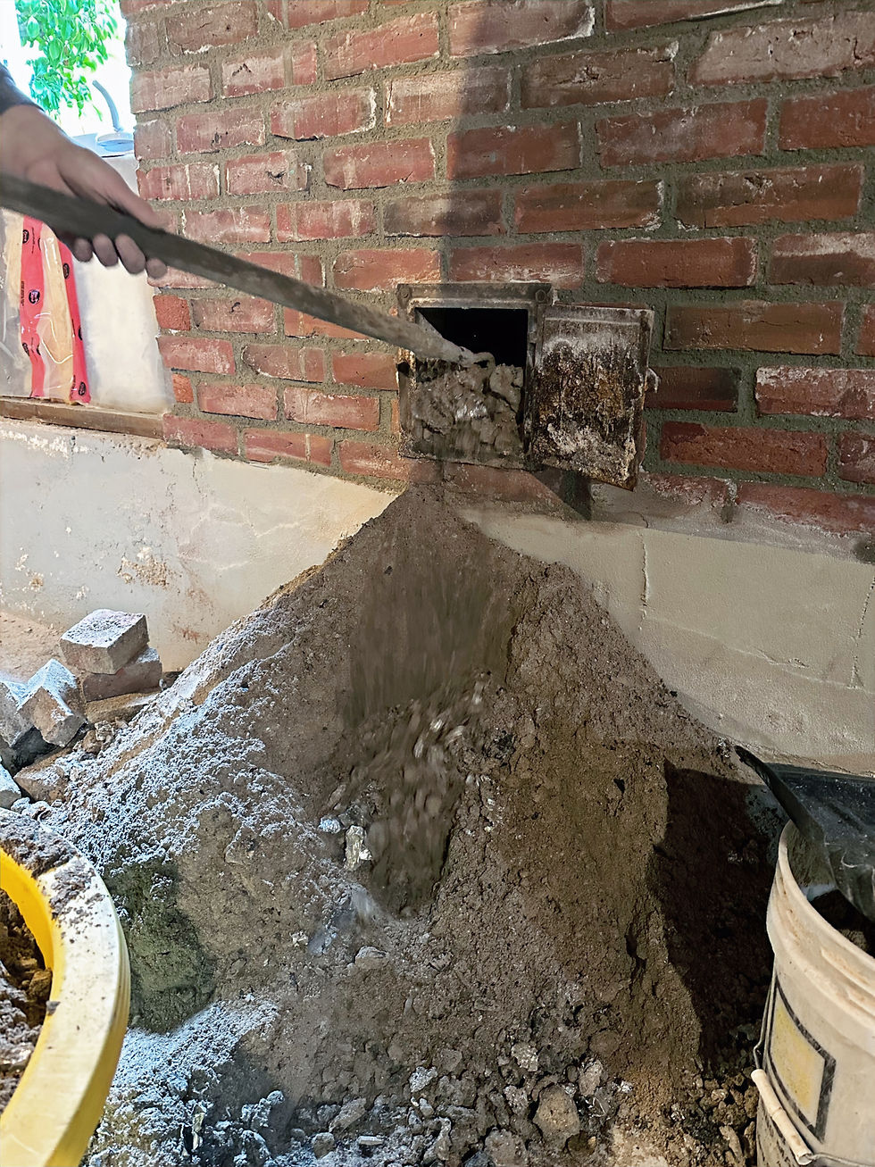 Soot being pulled out of a brick chimney by Island Chimney in Victoria, BC