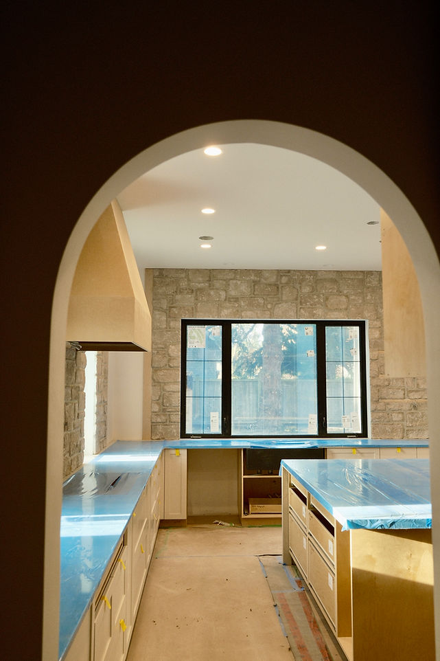 A limestone veneer applied to a kitchen backsplash in a new home in Ten Mile Point, Victoria BC by Lennox Masonry