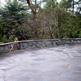 Stone retaining walls and a stone patio built by Lennox Masonry in Victoria BC
