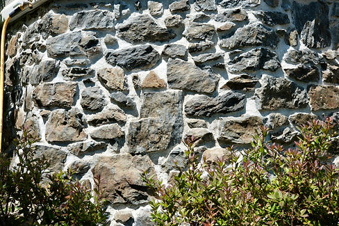 A heritage stone wall that has been repointed with traditional lime mortar by Lennox Masonry in the Cowichan Valley