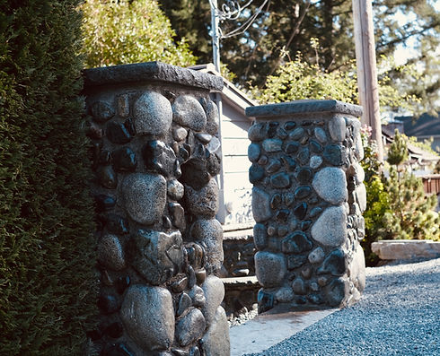 Stone pillars and retaining walls built from river rocks by Lennox Masonry in Mill Bay, BC