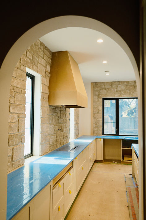 A thin stone veneer applied to the kitchen backsplash of a new home in Victoria, BC's Ten Mile Point by Lennox Masonry