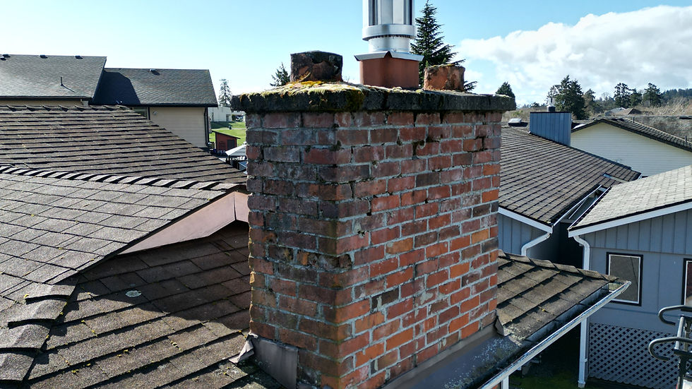 A brick chimney and cap that are falling apart and being repaired by Island Chimney Solutions in Victoria BC