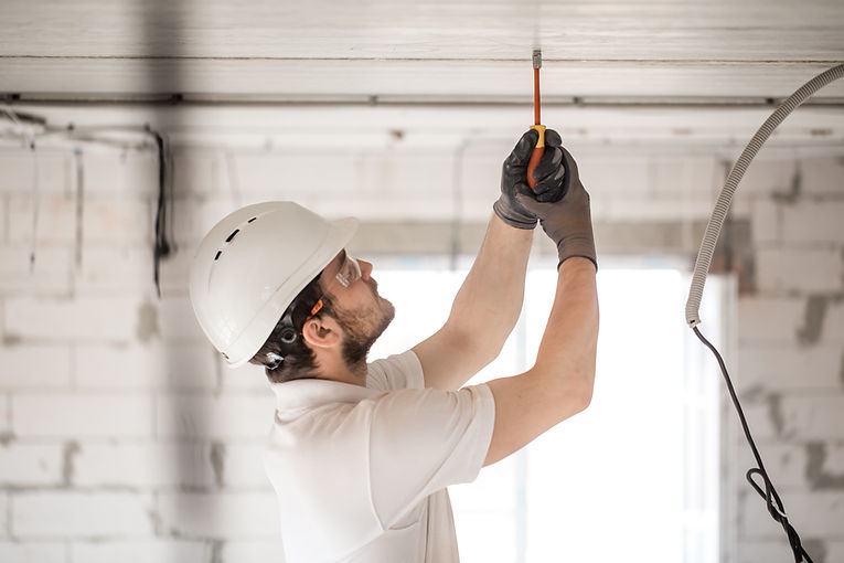 electrician-installer-with-tool-his-hands-working-with-cable-construction-site.jpg