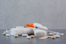 band-aid-plasters-pills-bandage-syringe-marble-surface (1).jpg