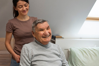 elderly-person-being-taken-care-by-female-caretaker.jpg