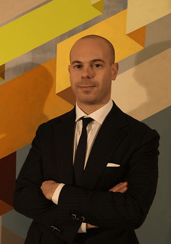 a man in a suit and tie posing for a picture