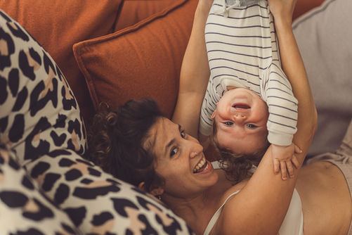 Mom holding her child playfully