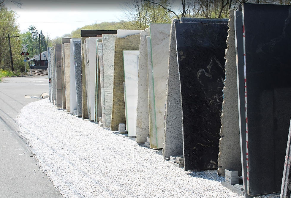 Eye-level view of a showroom displaying various marble slabs and quartz surfaces