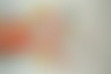 Colored plastic straws scattered on a white surface, with some cut into pieces. Bright red, yellow, blue, and pink hues dominate the scene.