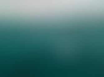 A blue boat near circular fish pens on a calm sea under a cloudy sky, with distant land visible. Yellow buoys float nearby.