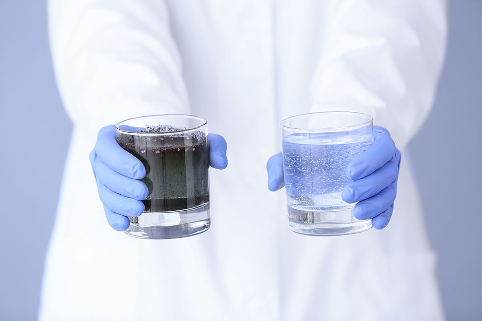 Person in lab coat and blue gloves holds two glasses of water, one murky and one clear, against a light blue background.