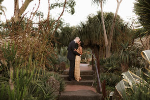 Jess and Elliott walking through the Royal Botanic Gardens at sunset on their wedding day