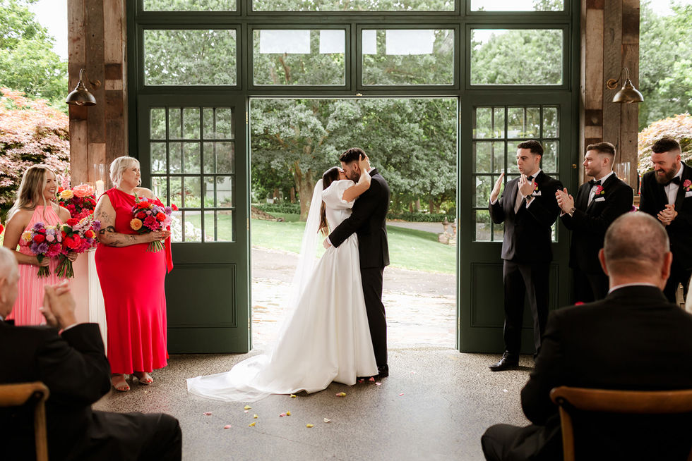 Sam and Mitch exchanging vows in their indoor Plan B space at Flowerdale Estate