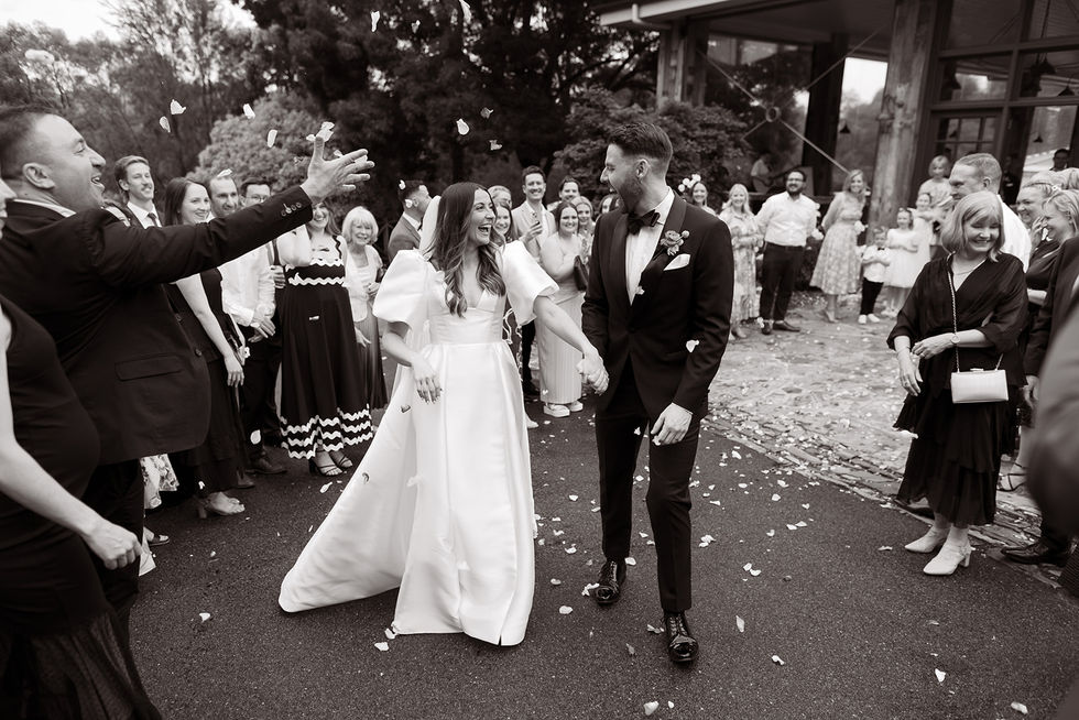 Sam and Mitch exchanging vows in their indoor Plan B space at Flowerdale Estate