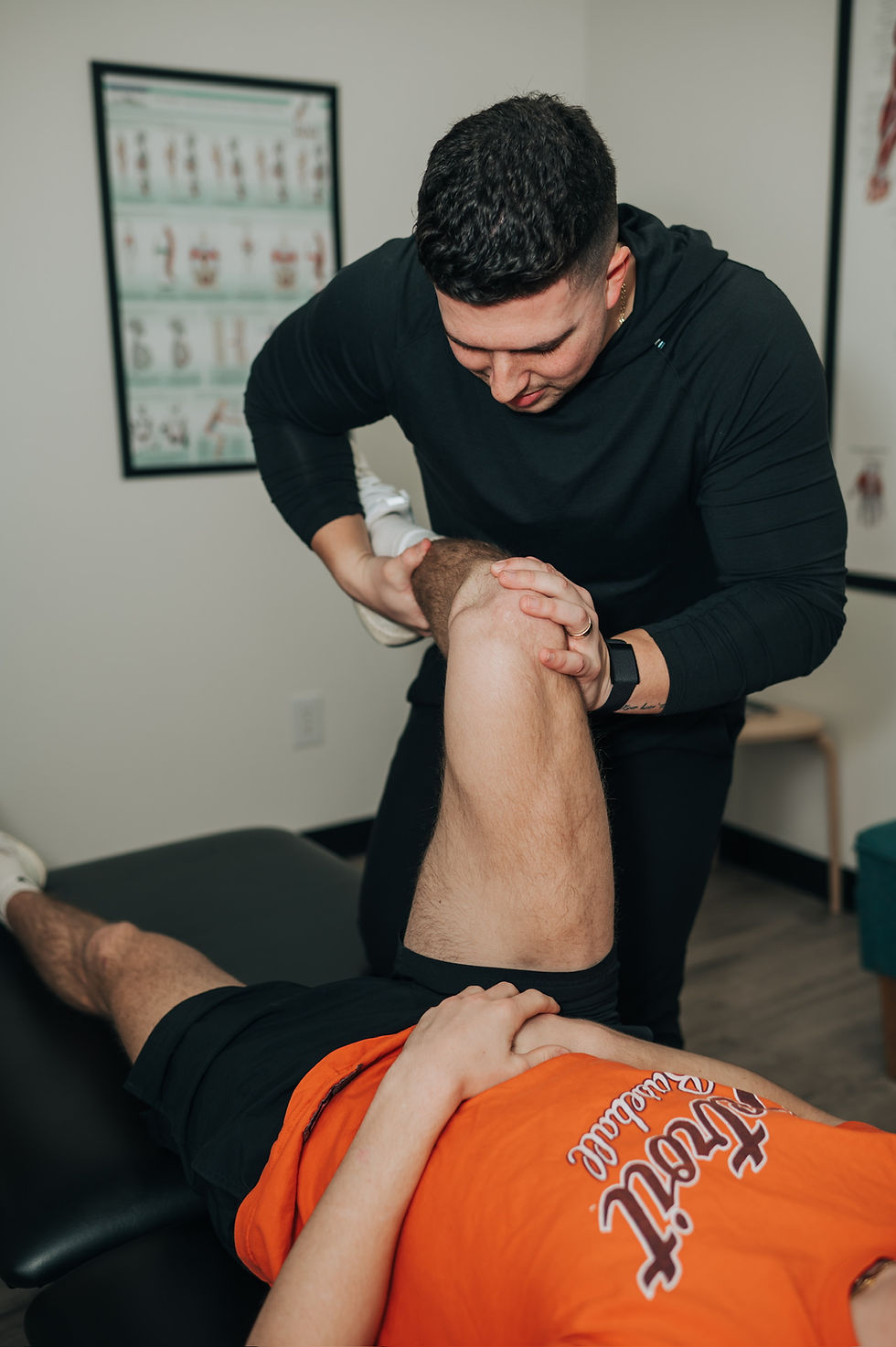 Chiropractor assessing patient's movement